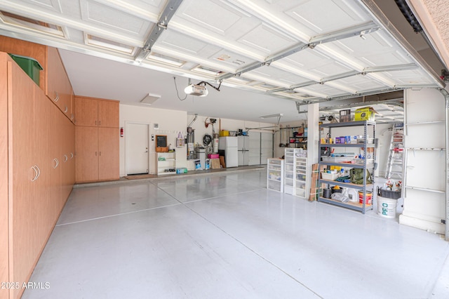 21841 N Ingram Ct, Maricopa, AZ 85138 - garage featuring a garage door opener and freestanding refrigerator