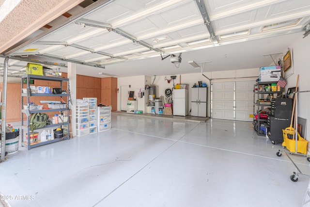 21841 N Ingram Ct, Maricopa, AZ 85138 - garage featuring freestanding refrigerator, water heater, and a garage door opener