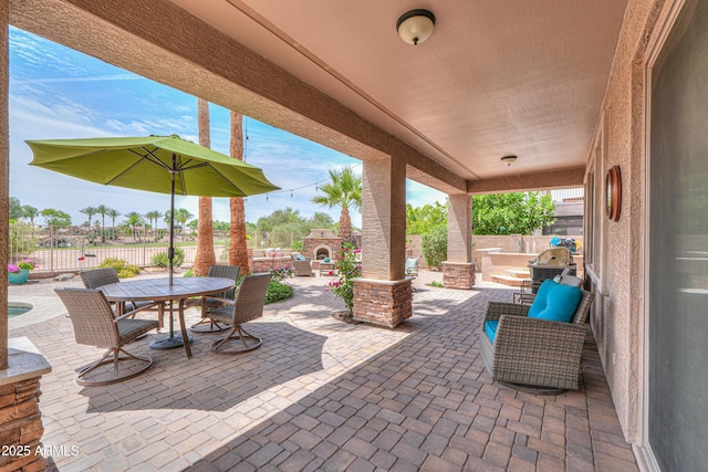 21841 N Ingram Ct, Maricopa, AZ 85138 - fenced backyard featuring an outdoor stone fireplace, a patio, and outdoor dining space