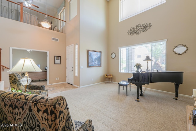 21841 N Ingram Ct, Maricopa, AZ 85138 - sitting room featuring a towering ceiling, carpet flooring, ceiling fan, and baseboards