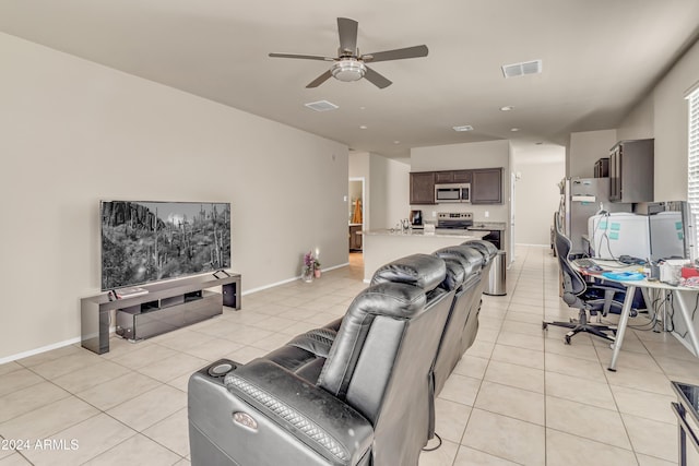 living room with light tile patterned floors, visible vents, and a ceiling fan