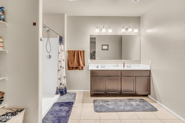 bathroom featuring tile patterned floors, curtained shower, and a sink