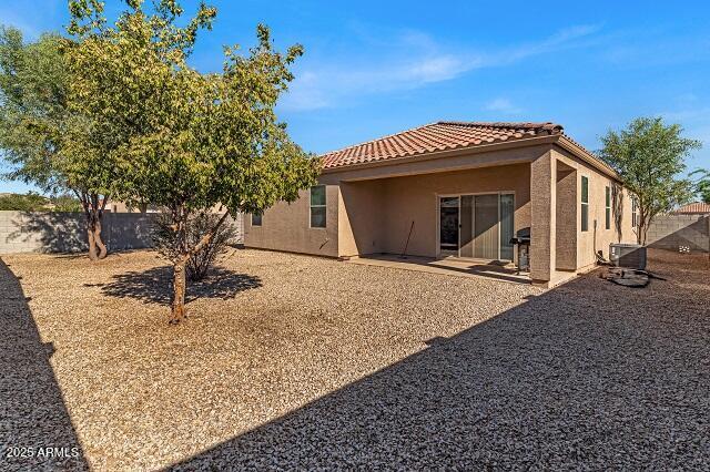 rear view of property featuring a patio area and cooling unit