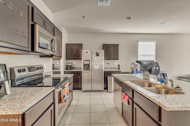 kitchen featuring light tile patterned floors, a sink, appliances with stainless steel finishes, visible vents, and light countertops