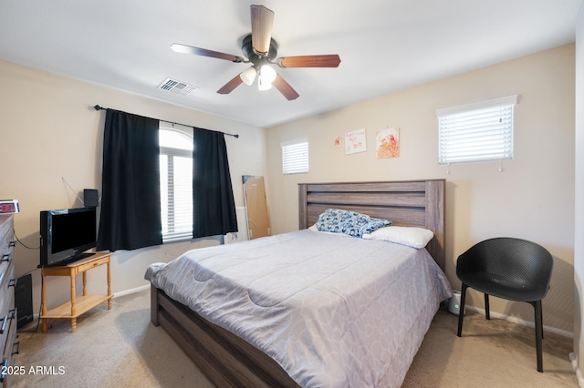 bedroom featuring visible vents, baseboards, carpet, and a ceiling fan