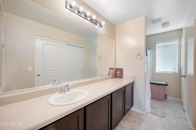 bathroom featuring vanity and baseboards