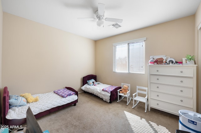 bedroom with visible vents, carpet, and ceiling fan