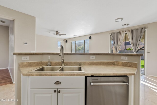 kitchen featuring dishwasher, white cabinets, sink, ceiling fan, and light tile patterned flooring