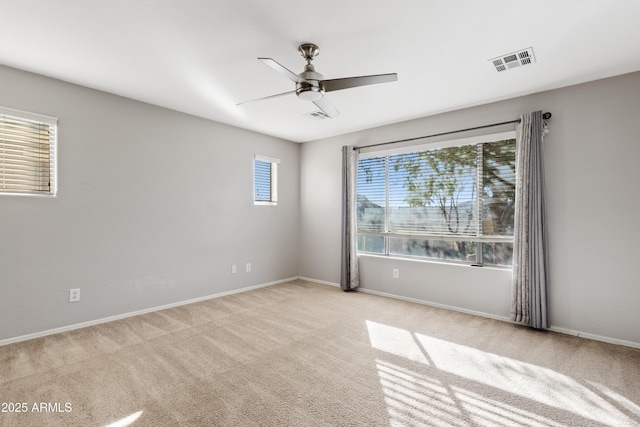 carpeted spare room with ceiling fan