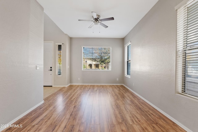 empty room with ceiling fan and light wood-type flooring