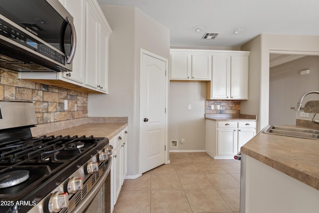 kitchen with white cabinetry, sink, and stainless steel appliances