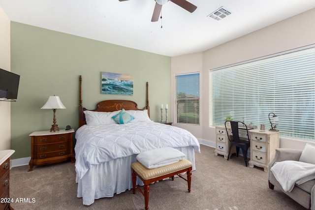 bedroom featuring light colored carpet, visible vents, ceiling fan, and baseboards