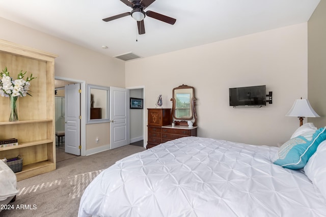 carpeted bedroom featuring a ceiling fan, visible vents, and baseboards