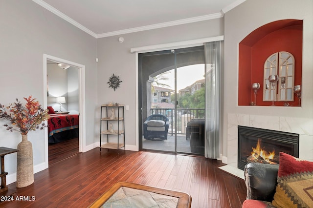 interior space featuring a premium fireplace, crown molding, and dark hardwood / wood-style flooring