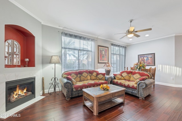 living room with ornamental molding, dark hardwood / wood-style floors, and a fireplace