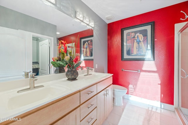 bathroom with vanity, toilet, walk in shower, and tile patterned flooring