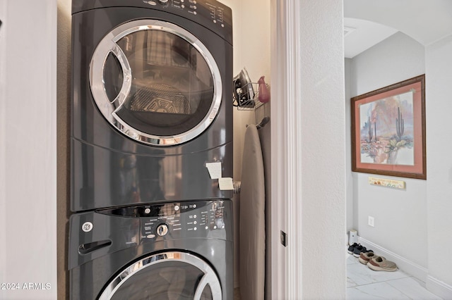 laundry room featuring stacked washer and clothes dryer