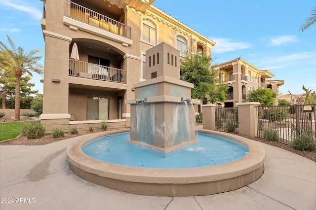 view of swimming pool with pool water feature