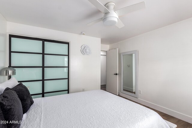 bedroom featuring ceiling fan and dark hardwood / wood-style floors