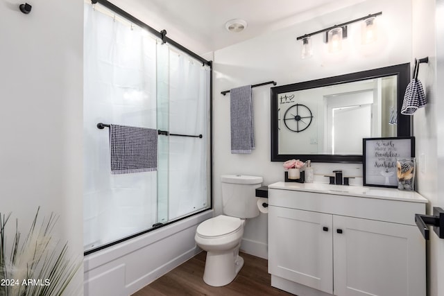 full bathroom with vanity, hardwood / wood-style flooring, toilet, and enclosed tub / shower combo