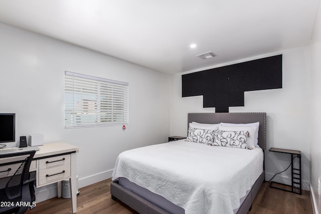 bedroom with dark hardwood / wood-style flooring