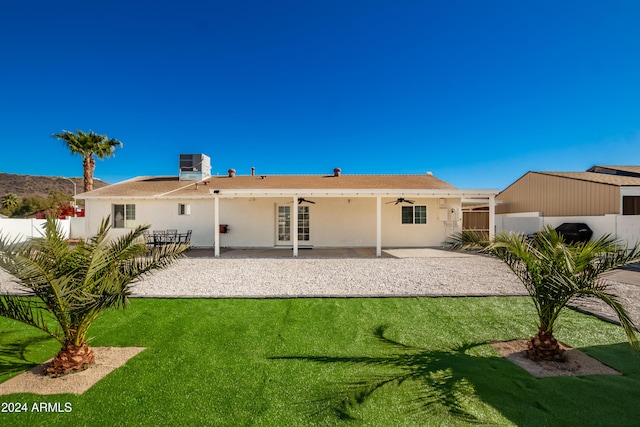 rear view of house featuring a lawn, ceiling fan, a patio, and central AC