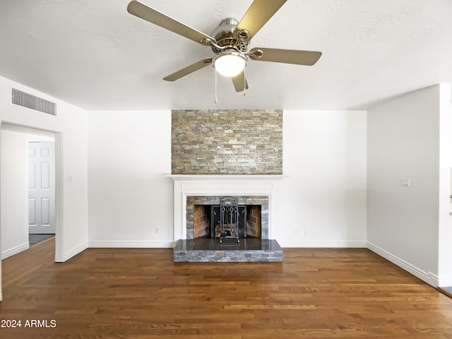 unfurnished living room with ceiling fan, a fireplace, and hardwood / wood-style floors