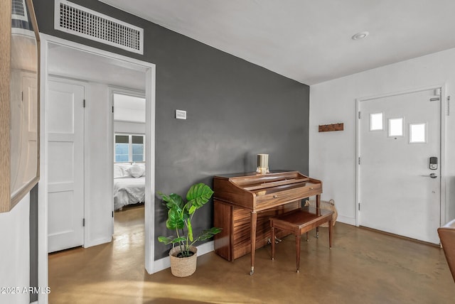 foyer entrance with a wealth of natural light and concrete floors