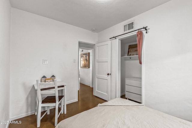 bedroom featuring dark wood-type flooring