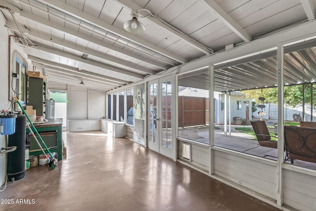 interior space featuring lofted ceiling with beams and water heater