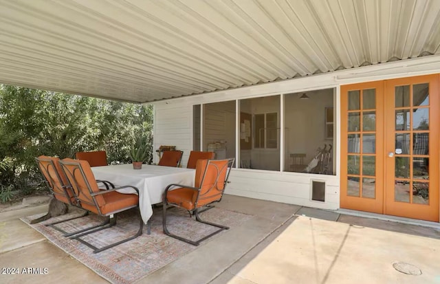 view of patio featuring french doors and a sunroom