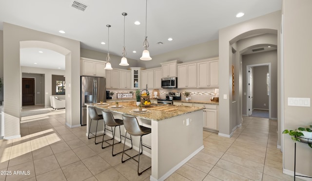 4341 E Evelyn St, Gilbert, AZ 85295 - kitchen with stainless steel appliances, arched walkways, light tile patterned floors, and recessed lighting