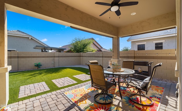 4341 E Evelyn St, Gilbert, AZ 85295 - fenced backyard featuring a patio, ceiling fan, and outdoor dining area