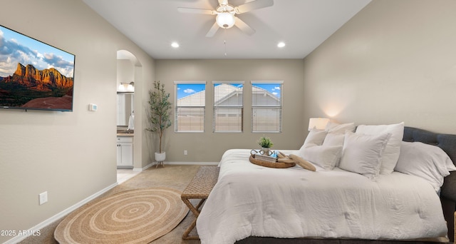4341 E Evelyn St, Gilbert, AZ 85295 - bedroom featuring light colored carpet, arched walkways, recessed lighting, ensuite bath, and a ceiling fan