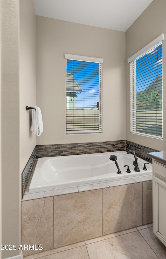 4341 E Evelyn St, Gilbert, AZ 85295 - bathroom featuring a garden tub, vanity, and tile patterned flooring