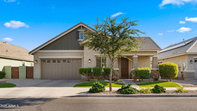 4341 E Evelyn St, Gilbert, AZ 85295 - view of front facade featuring decorative driveway, stone siding, stucco siding, and a garage