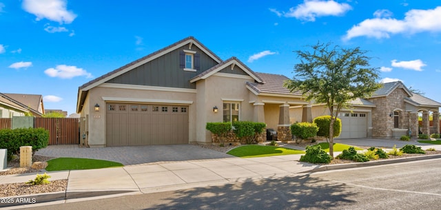 4341 E Evelyn St, Gilbert, AZ 85295 - view of front of house with driveway, an attached garage, a gate, and stucco siding