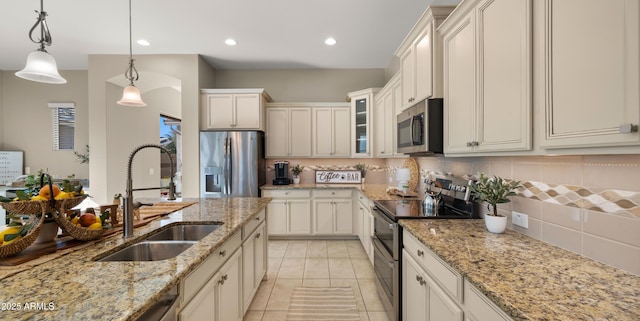 4341 E Evelyn St, Gilbert, AZ 85295 - kitchen featuring appliances with stainless steel finishes, tasteful backsplash, decorative light fixtures, glass insert cabinets, and recessed lighting