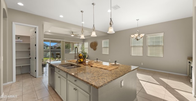 4341 E Evelyn St, Gilbert, AZ 85295 - kitchen featuring light tile patterned floors, a kitchen island with sink, a ceiling fan, hanging light fixtures, and light stone countertops