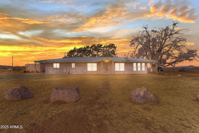 property exterior at dusk with a yard