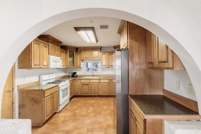 kitchen featuring sink and white appliances