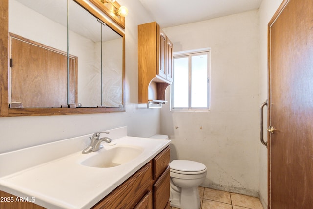 bathroom featuring vanity, toilet, and tile patterned flooring