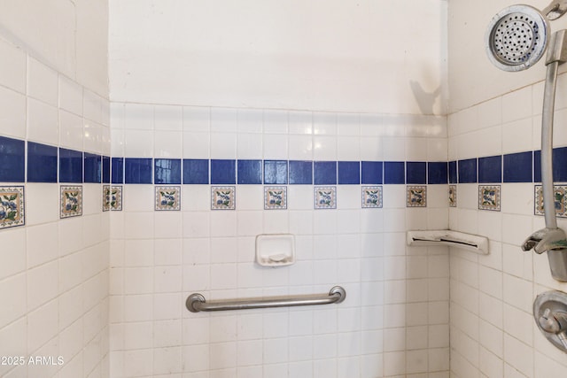 bathroom with tiled shower