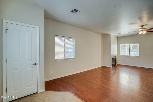 unfurnished room with ceiling fan and light hardwood / wood-style flooring