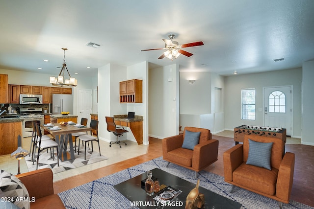 living room featuring light hardwood / wood-style flooring and ceiling fan