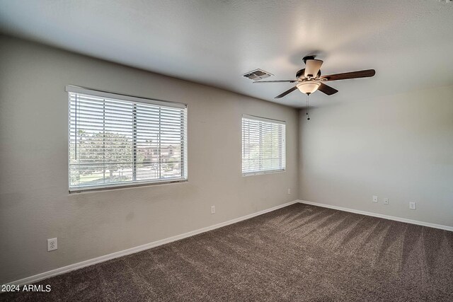 unfurnished room with ceiling fan and carpet floors