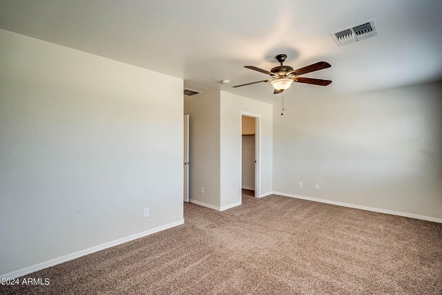 empty room featuring ceiling fan and carpet floors