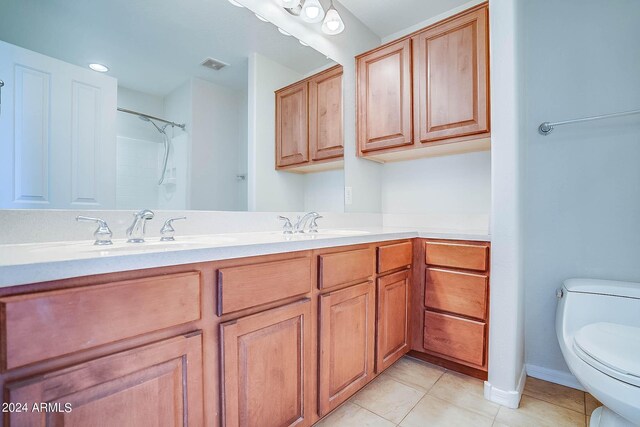 bathroom featuring vanity, toilet, walk in shower, and tile patterned flooring