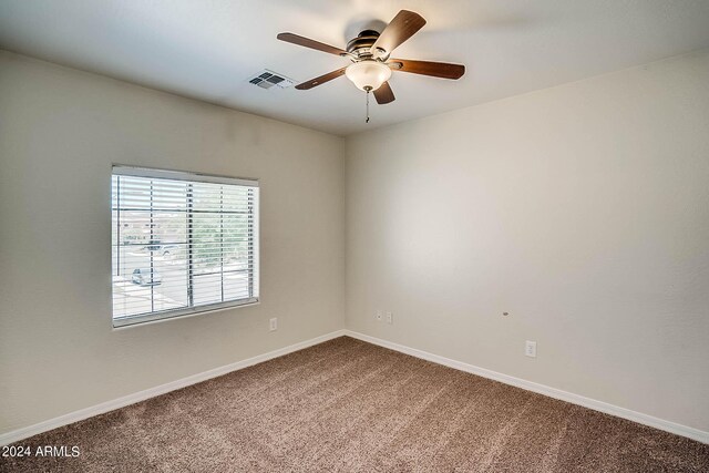 spare room with ceiling fan and carpet floors