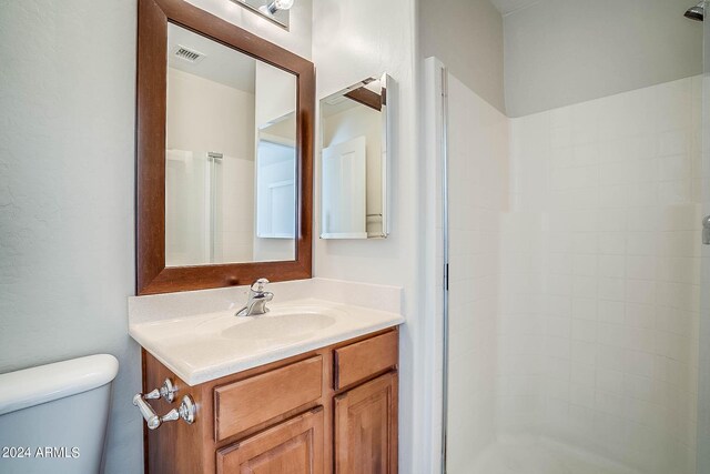 bathroom with vanity, toilet, and an enclosed shower